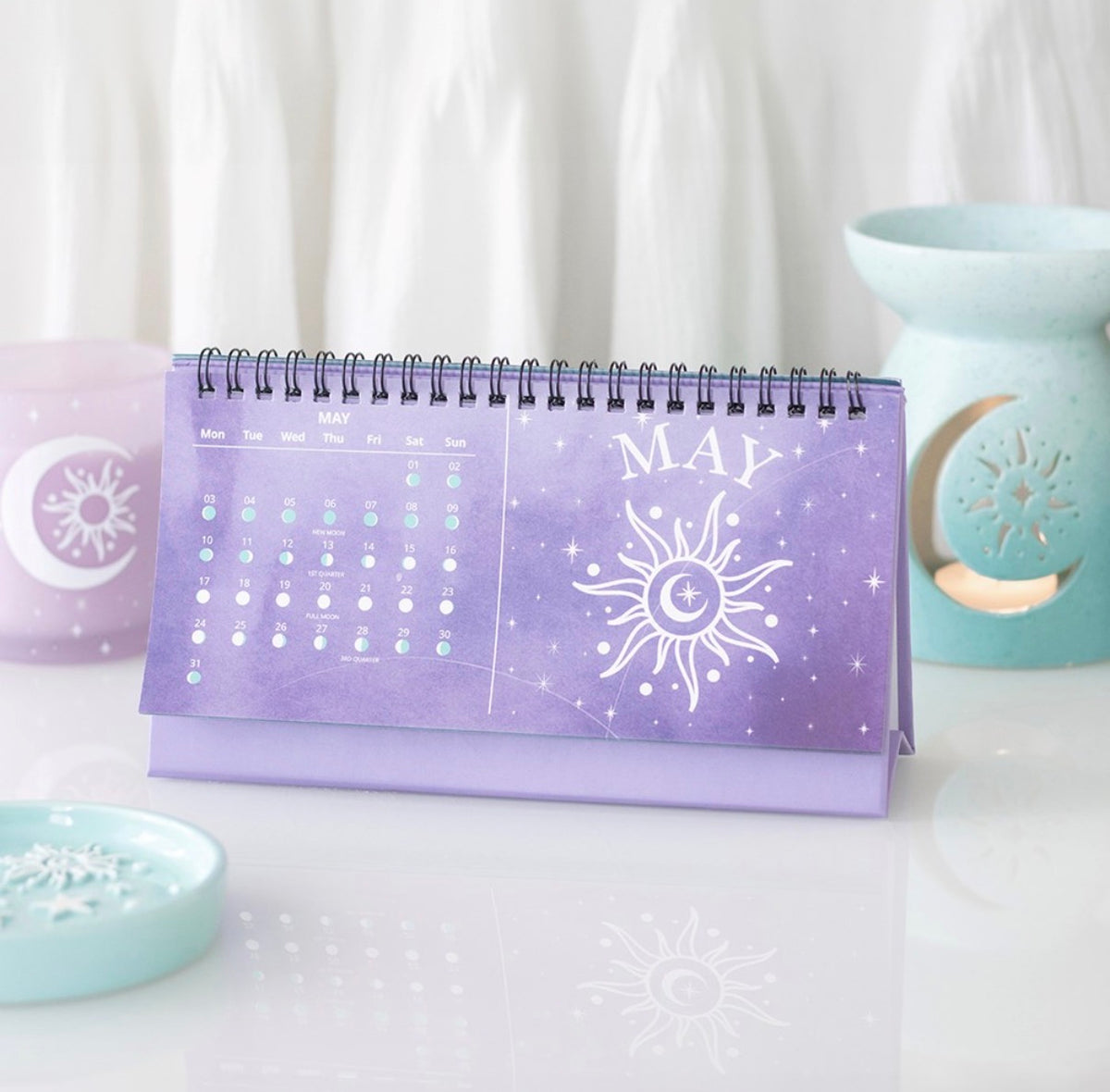 May page of the moon phase calendar showing daily moon phases and a sun illustration