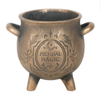 Plain side of the antiqued bronze cauldron pot showing its handles and three feet