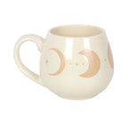 Cream moon phase ceramic mug with the handle to the left, showing the raised moon design