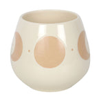 Cream moon phase ceramic mug with the handle to the right, showing crescent moons and stars