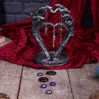 Skeleton hands heart jewellery stand - lifestyle with crystals