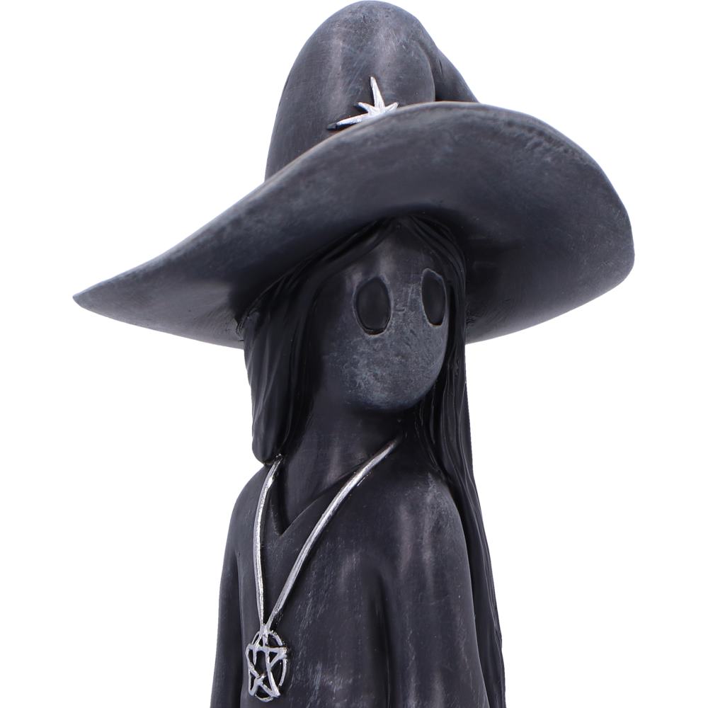 Little Souls Sparkle witch figurine - lifestyle shot in dark library