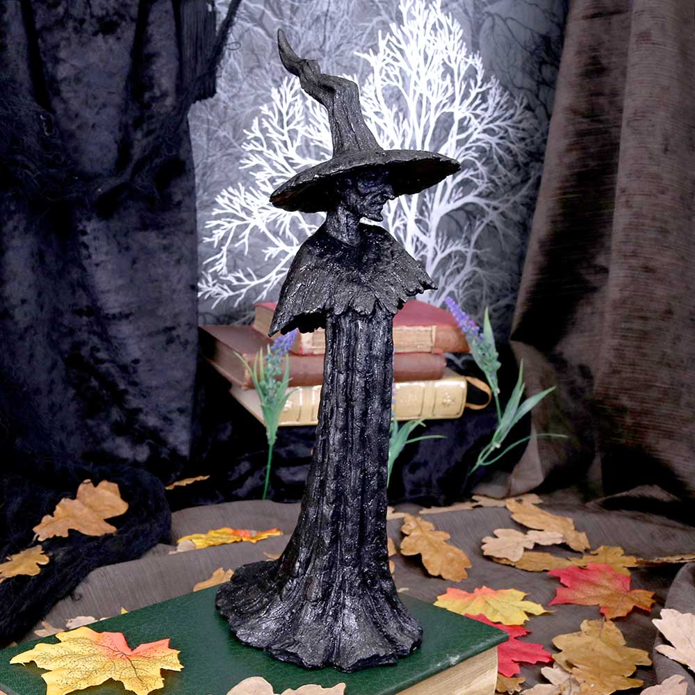 Familiar Forests Witch Figurine - lifestyle shot with autumn leaves