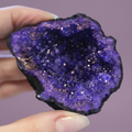 Dyed Amethyst Geode - hand shot, purple background