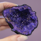 Dyed Amethyst Geode - hand shot, purple background