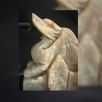 Close-up of the hand-carved moonstone dragon head and wing