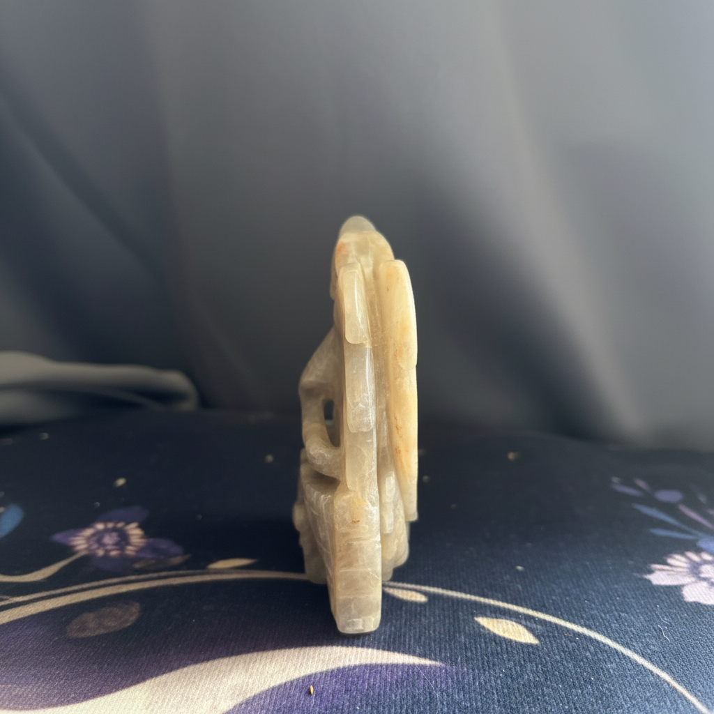 Rear angled view of the carved moonstone dragon wings and base