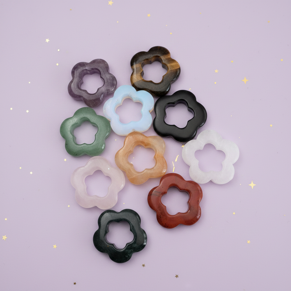 Collection of crystal flower orb holders in various colours on pale purple background with gold stars