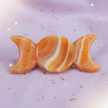 Orange Calcite Triple Moon Goddess Carving on pale purple background with gold stars