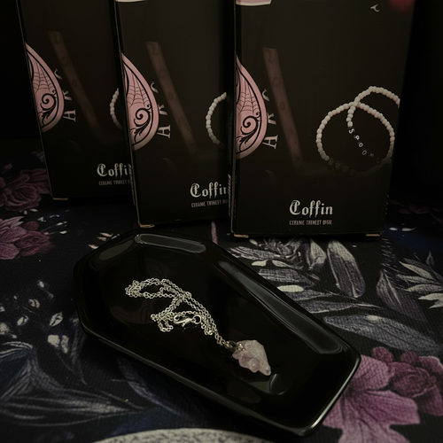 Black coffin trinket dish with crystal necklace and gift boxes