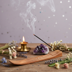Satya Super Hit incense sticks burning with smoke curling upward, amethyst crystals and candlelight on pale purple starry background