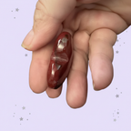Red Jasper Heart - side profile in hand, pale purple stars