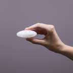 Selenite Palm Stone - hand shot, purple background