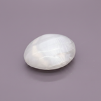 Selenite Palm Stone - surface, purple background
