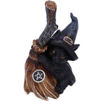 Witchy Black Cat Broomstick Figurine - lifestyle shot on wooden surface with skull backdrop