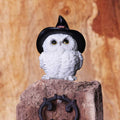 Witchy White Owl Figurine - lifestyle shot perched on rustic wooden post with iron bracket