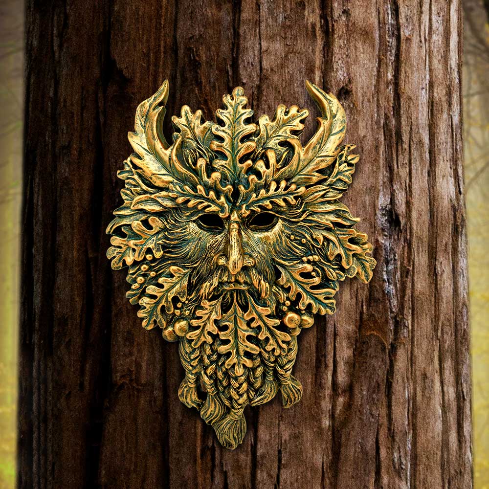 Green Man wall plaque mounted on tree bark