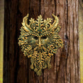 Green Man wall plaque mounted on tree bark