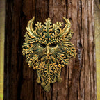 Green Man wall plaque mounted on tree bark