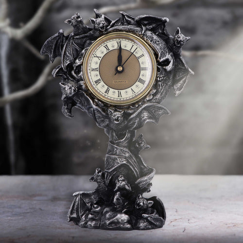 Gothic bat mantel clock styled on stone surface with misty background