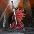 Red dragon sword figurine styled in dramatic fantasy setting