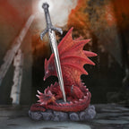 Red dragon sword figurine styled in dramatic fantasy setting