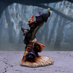 Witch cats broomstick figurine full view on cracked stone surface