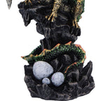 Green dragon figurine styled in dramatic misty forest setting