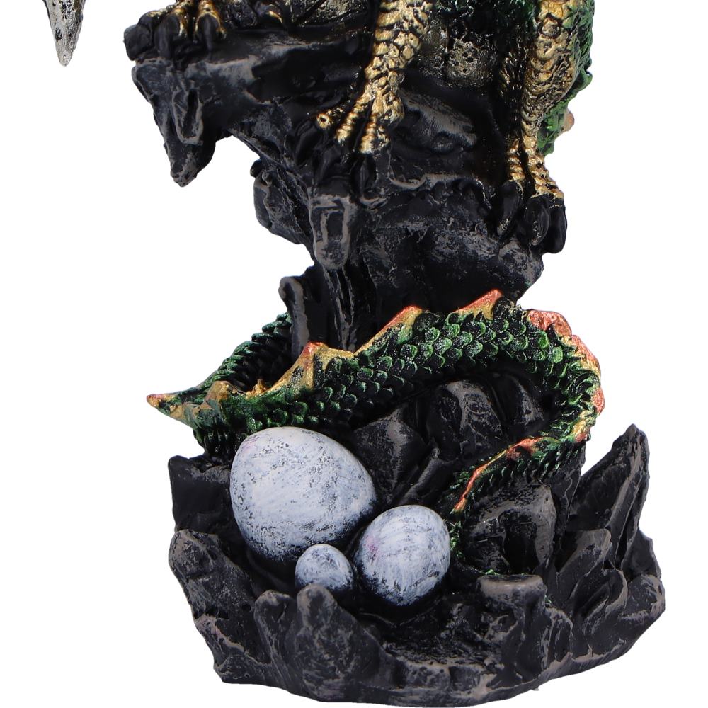 Green dragon figurine styled in dramatic misty forest setting