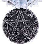 White owl pentagram wall hanging displayed on dark tree bark in snowy forest